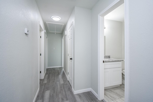 corridor with light hardwood / wood-style floors