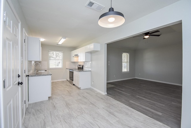 kitchen featuring white cabinetry, ceiling fan, tasteful backsplash, light stone countertops, and electric stove