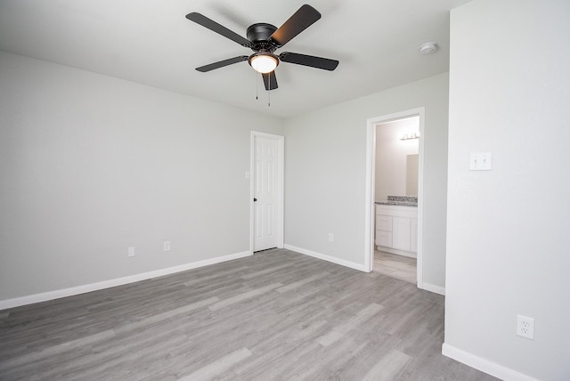 unfurnished bedroom with ensuite bath, ceiling fan, and light hardwood / wood-style flooring