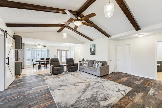 unfurnished living room featuring ceiling fan, lofted ceiling with beams, a barn door, and a textured ceiling