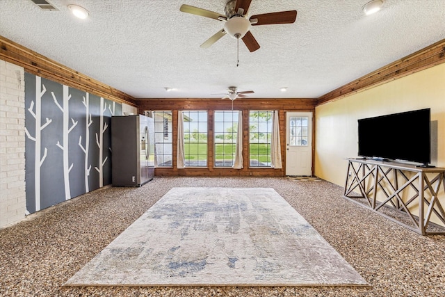 living room with a textured ceiling and ceiling fan