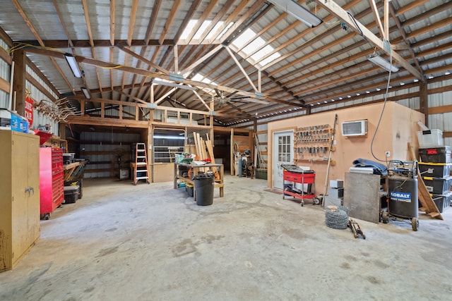 garage featuring an AC wall unit and a workshop area