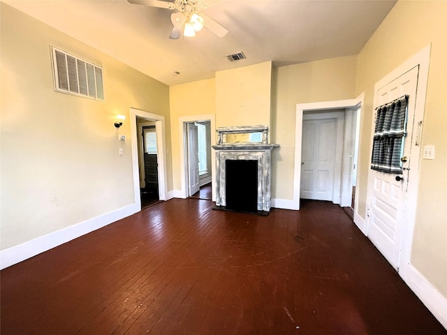 unfurnished living room featuring dark hardwood / wood-style flooring and ceiling fan