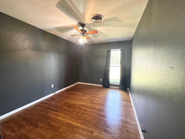 empty room featuring ceiling fan and wood-type flooring