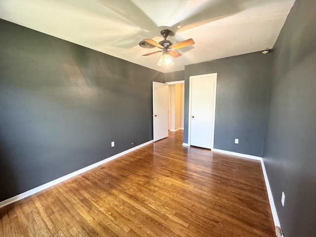 unfurnished bedroom with ceiling fan and hardwood / wood-style flooring