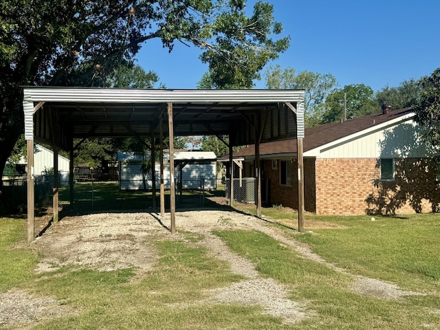 view of vehicle parking featuring a yard and a carport