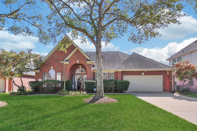 view of front of house with a front yard and a garage