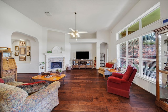 living room with plenty of natural light, dark hardwood / wood-style floors, and ceiling fan