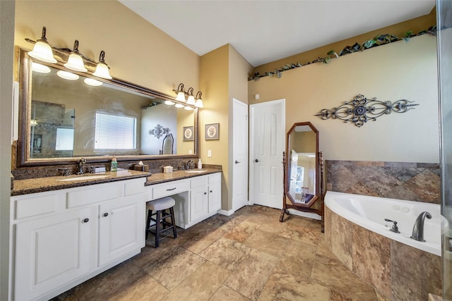 bathroom with vanity and independent shower and bath