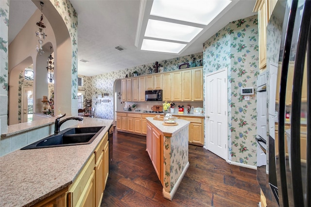 kitchen with dark wood-type flooring, sink, light brown cabinets, a kitchen island, and black appliances