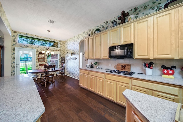 kitchen with dark hardwood / wood-style floors, pendant lighting, a chandelier, black appliances, and a textured ceiling