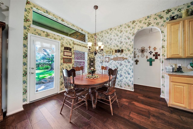 dining area featuring an inviting chandelier and dark hardwood / wood-style flooring