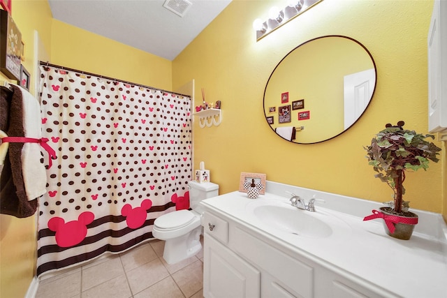 bathroom featuring vanity, toilet, and tile patterned flooring