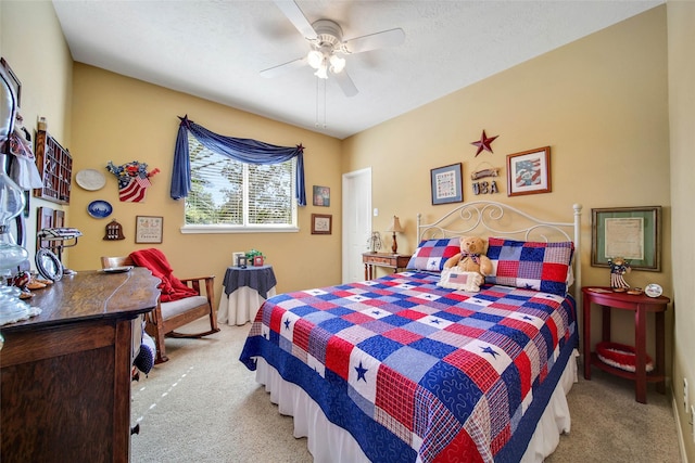 bedroom with light colored carpet, a textured ceiling, and ceiling fan