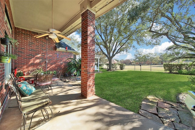 view of yard with a patio area and ceiling fan