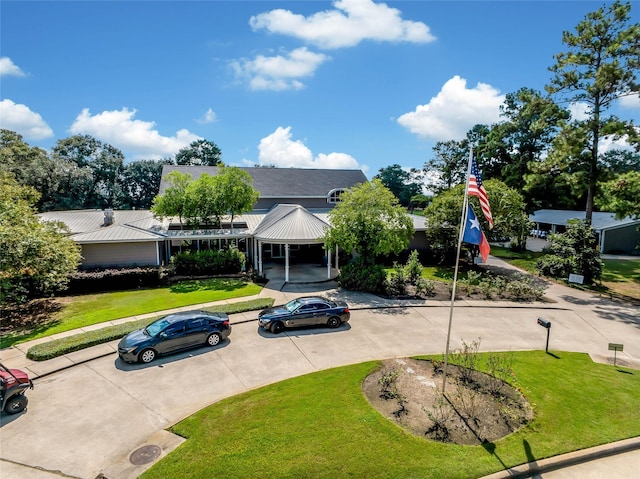 view of front facade featuring a front lawn and a carport