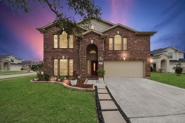 front of property with a garage and a lawn