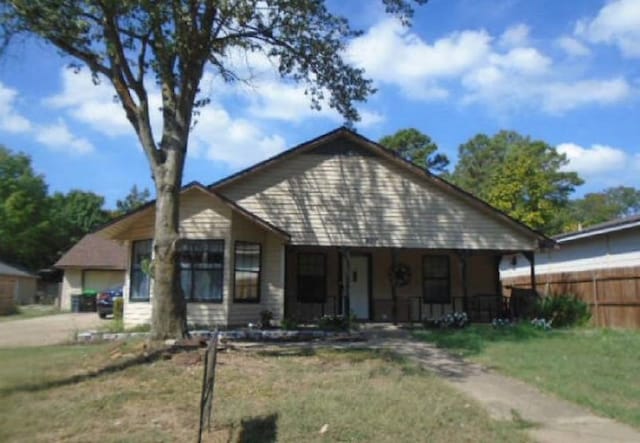 bungalow with a garage and a front lawn