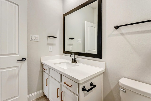 bathroom with toilet and vanity