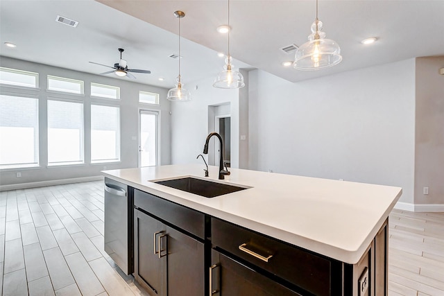 kitchen featuring sink, hanging light fixtures, a kitchen island with sink, and ceiling fan