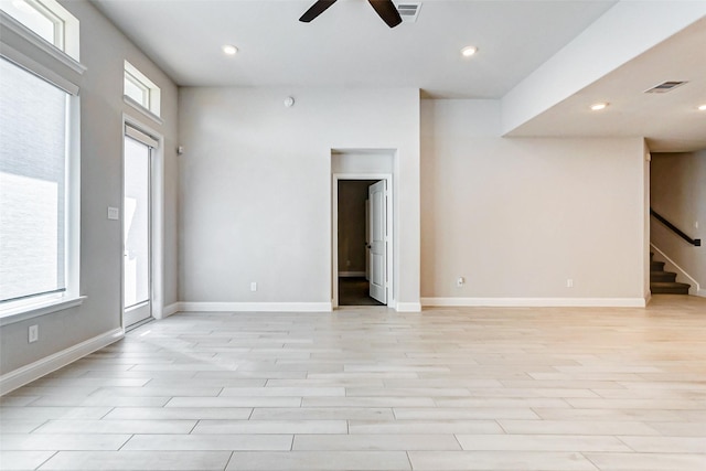 spare room with light wood-type flooring and ceiling fan