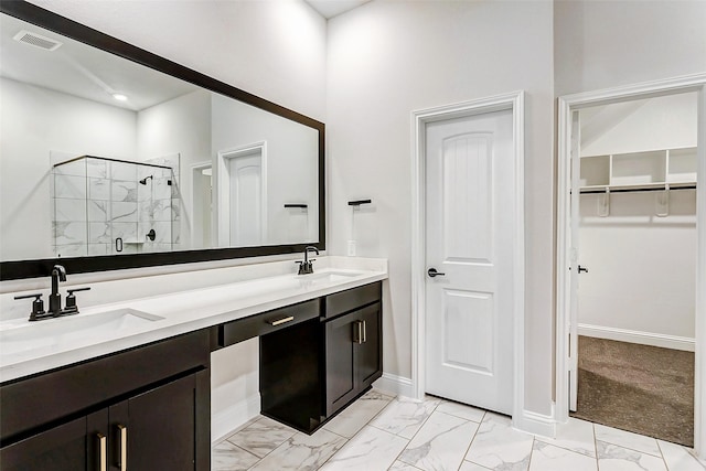 bathroom with vanity and a shower with shower door