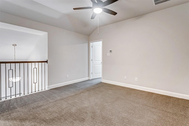 empty room with lofted ceiling, ceiling fan, and carpet