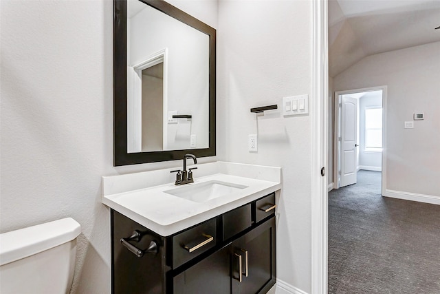 bathroom featuring vaulted ceiling, vanity, and toilet