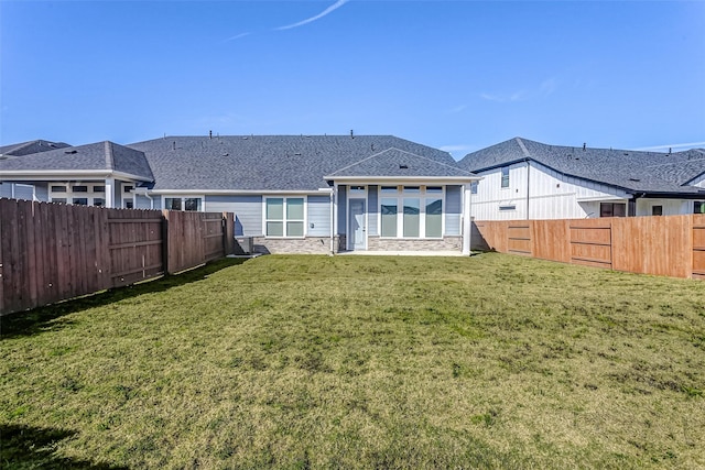 rear view of house featuring a yard