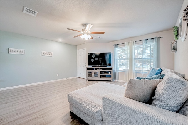 living room with ceiling fan and hardwood / wood-style floors