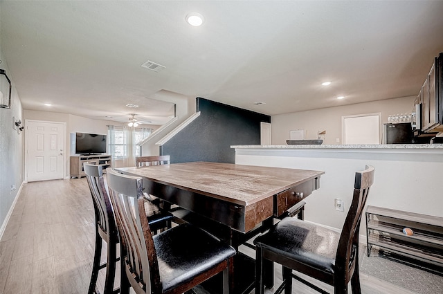 dining room with light wood-type flooring and ceiling fan