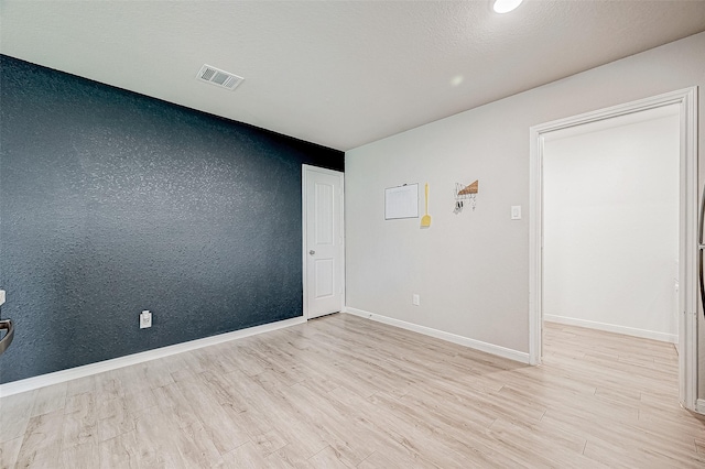 spare room featuring light hardwood / wood-style floors