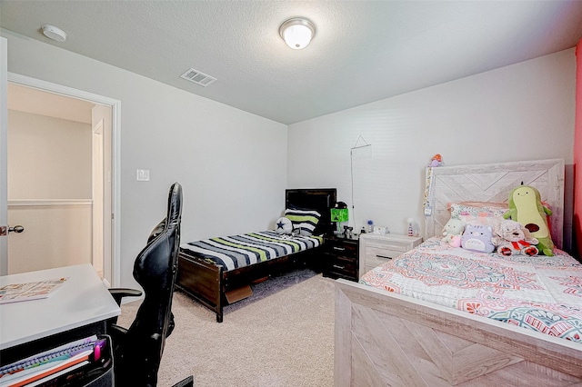 carpeted bedroom featuring a textured ceiling