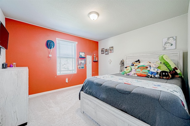 bedroom featuring light colored carpet and a textured ceiling