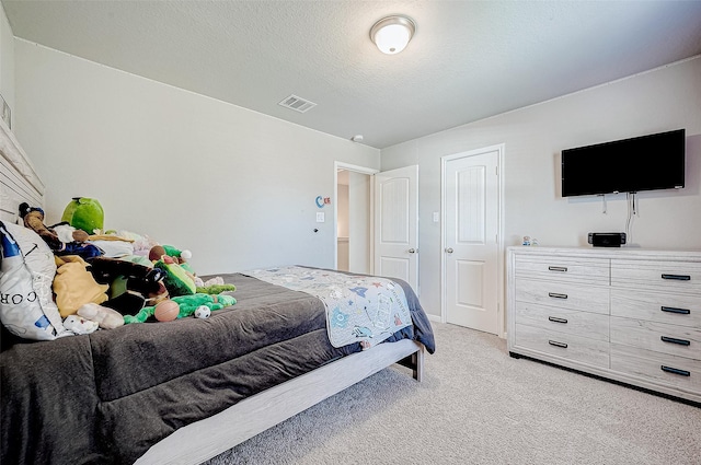 carpeted bedroom with a textured ceiling