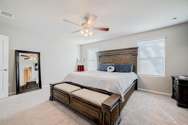 bedroom with light colored carpet and ceiling fan