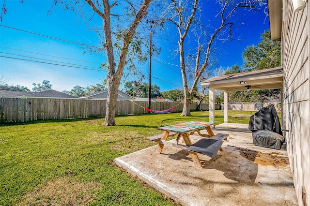 view of yard with ceiling fan and a patio area