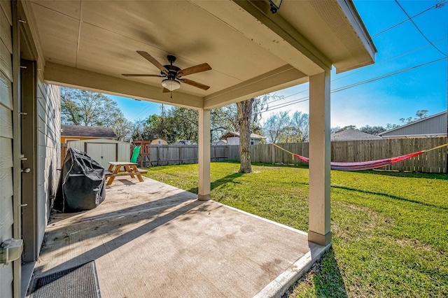 view of patio / terrace with a storage unit, ceiling fan, and a playground