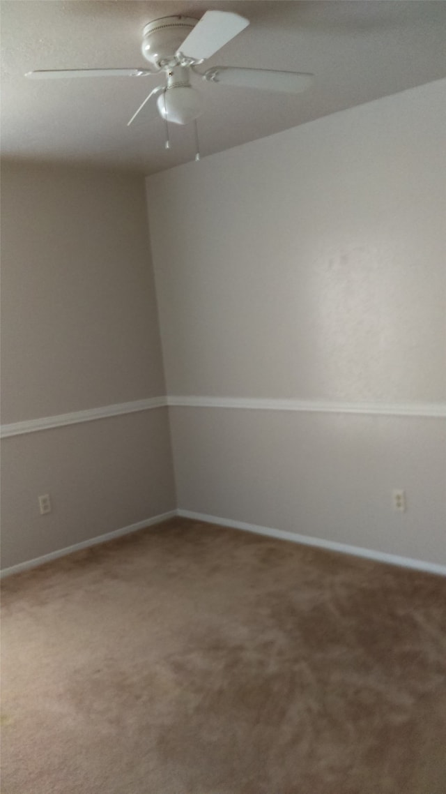 unfurnished room with ceiling fan and carpet flooring