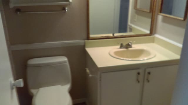 bathroom featuring toilet and vanity