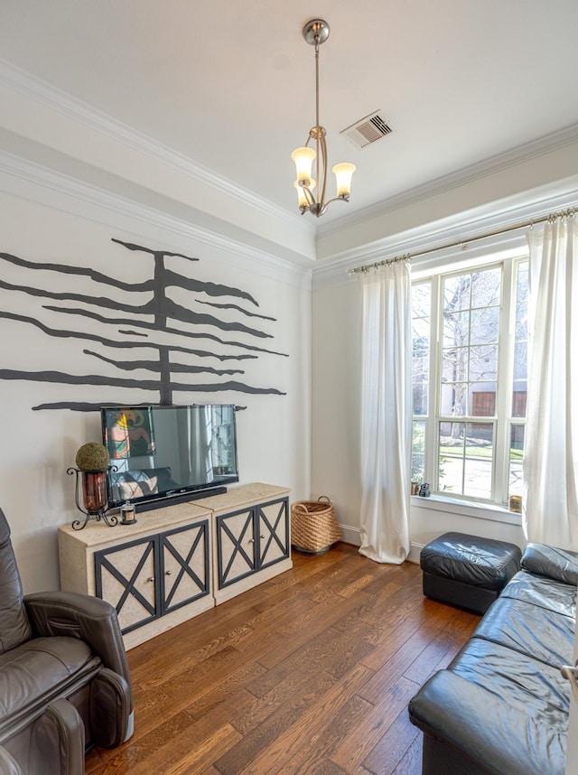 living room featuring a notable chandelier, crown molding, and dark hardwood / wood-style floors