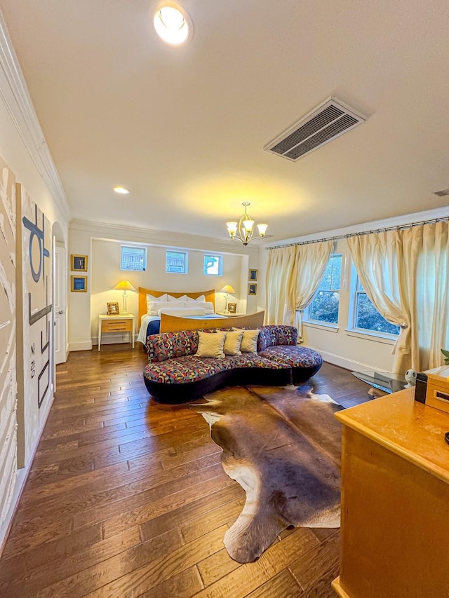 bedroom featuring a notable chandelier, dark wood-type flooring, and ornamental molding