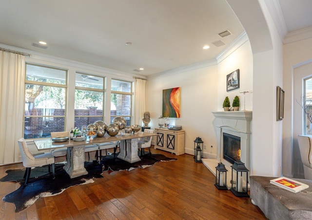 dining area with ornamental molding and hardwood / wood-style floors