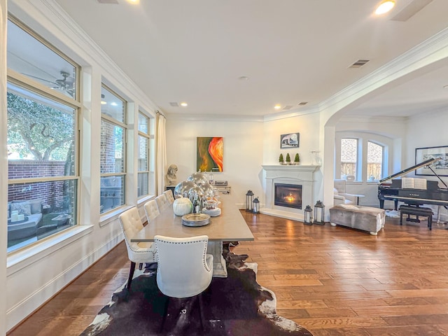 dining area with crown molding and dark hardwood / wood-style floors