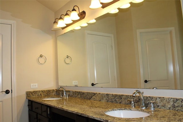 full bathroom with a sink and double vanity