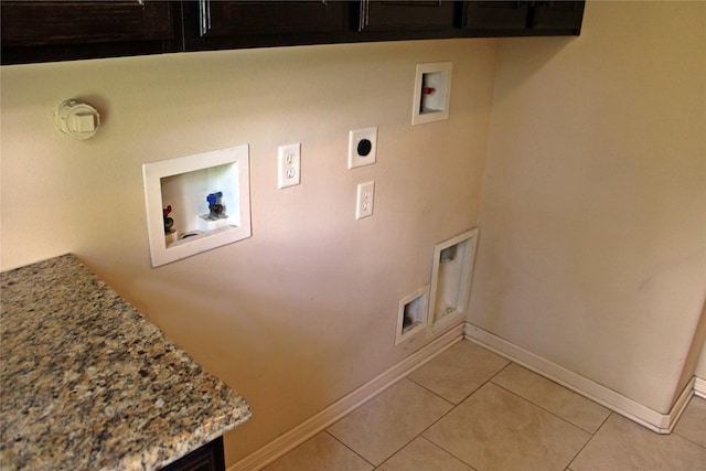 clothes washing area with cabinet space, light tile patterned floors, electric dryer hookup, baseboards, and hookup for a washing machine