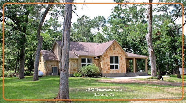 view of front of house with central air condition unit, stone siding, and a front yard