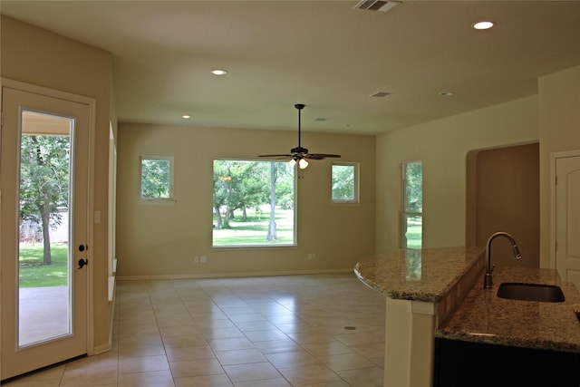 kitchen featuring visible vents, light stone counters, a sink, light tile patterned floors, and recessed lighting