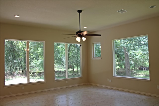 empty room with baseboards, recessed lighting, and plenty of natural light