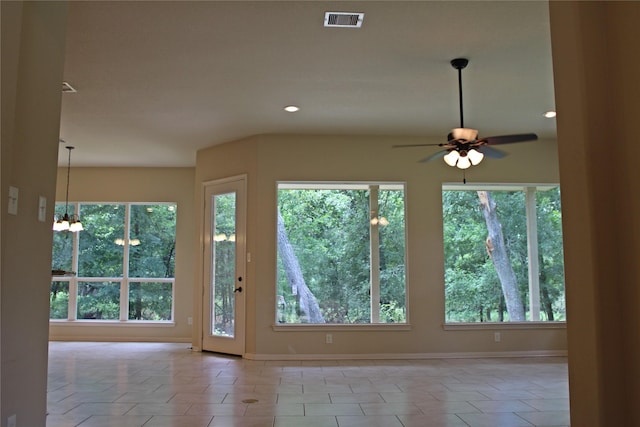 doorway to outside with plenty of natural light, visible vents, baseboards, and light tile patterned floors